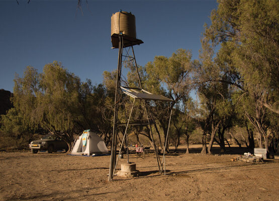 Campsite with tent, fireplace and water tank at Kudu Wild Camp