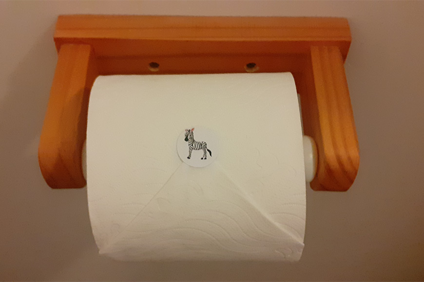 Zebra sticker on roll of toilet paper